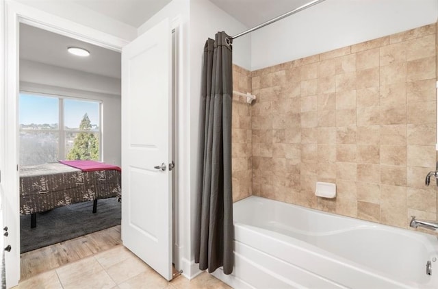 bathroom with tile patterned flooring and shower / bathtub combination with curtain