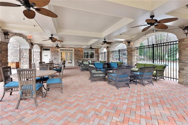 view of patio / terrace with fence, outdoor dining area, ceiling fan, french doors, and an outdoor hangout area