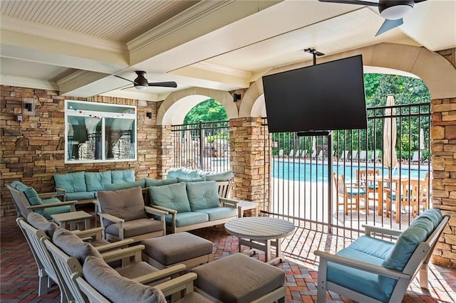 view of patio / terrace with a community pool, an outdoor hangout area, ceiling fan, and fence