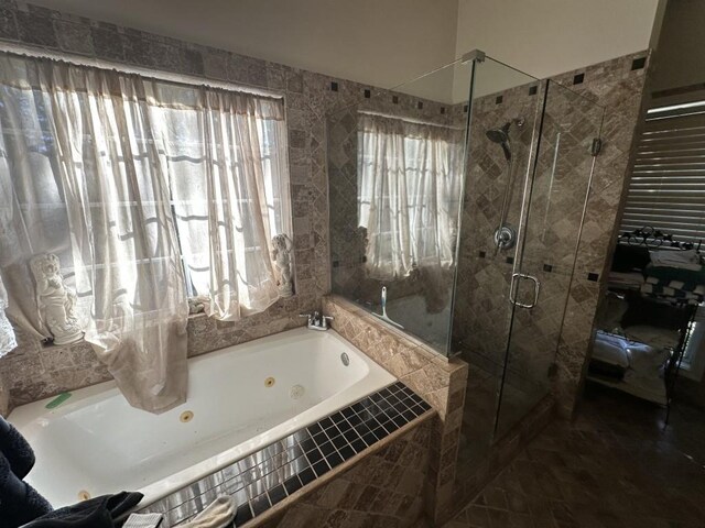 bathroom with tile patterned floors and independent shower and bath