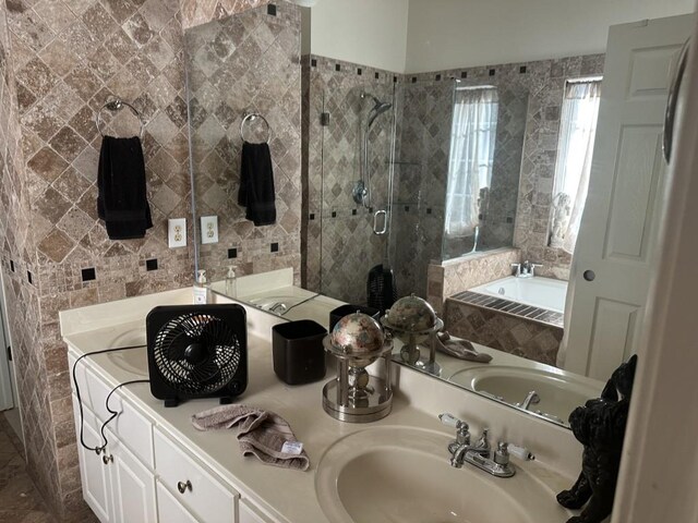 bathroom with vanity, tile walls, and independent shower and bath