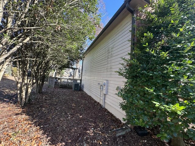 view of side of property featuring central air condition unit