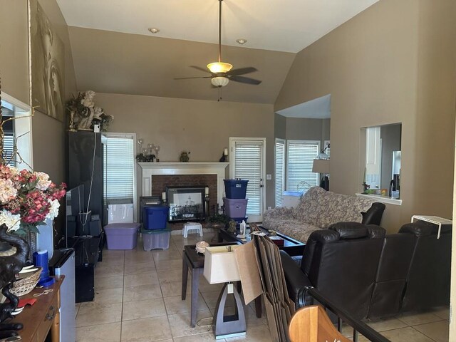 tiled living room featuring ceiling fan and vaulted ceiling