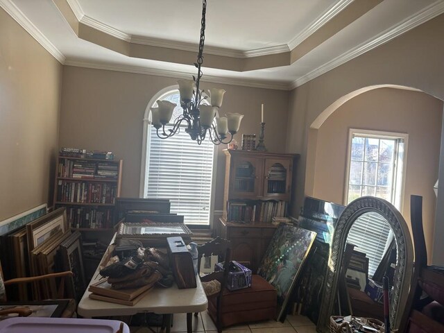 dining space featuring a raised ceiling, crown molding, light tile patterned floors, and a notable chandelier