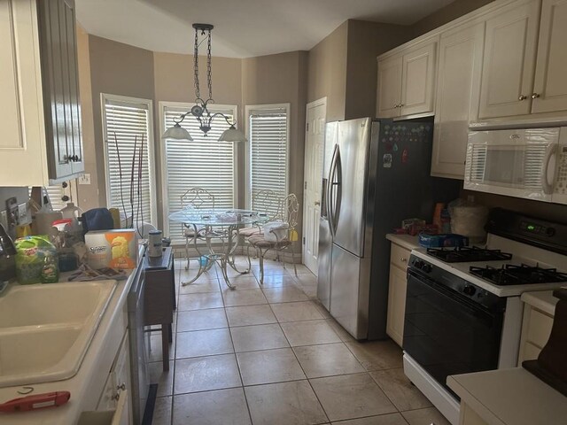 kitchen featuring pendant lighting, white appliances, an inviting chandelier, light tile patterned floors, and white cabinetry