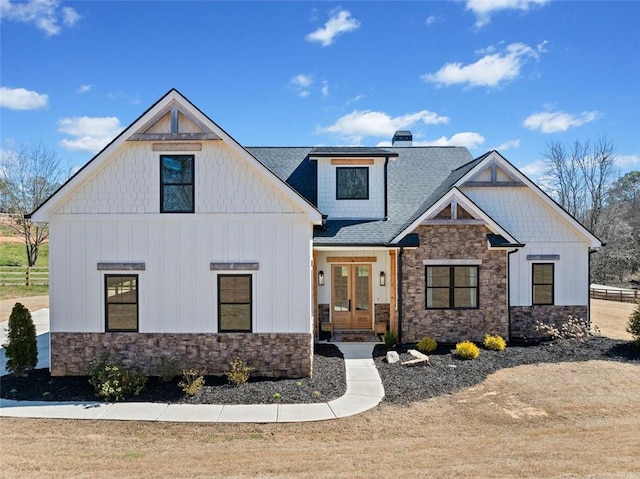 modern farmhouse with roof with shingles, french doors, and board and batten siding