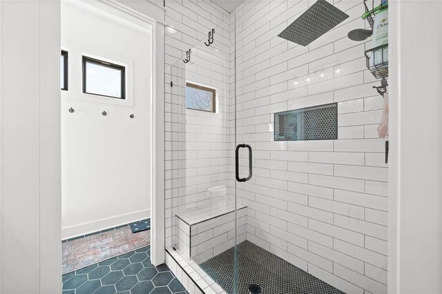 full bath featuring a shower stall and tile patterned flooring