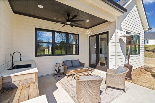 view of patio / terrace with ceiling fan, a sink, and an outdoor hangout area