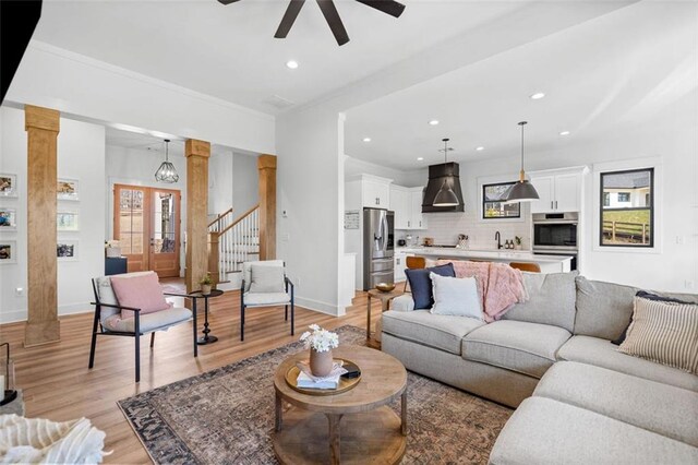 living room with baseboards, plenty of natural light, recessed lighting, and light wood-style floors