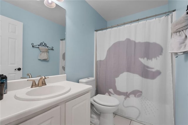 bathroom featuring toilet, tile patterned flooring, vanity, and curtained shower