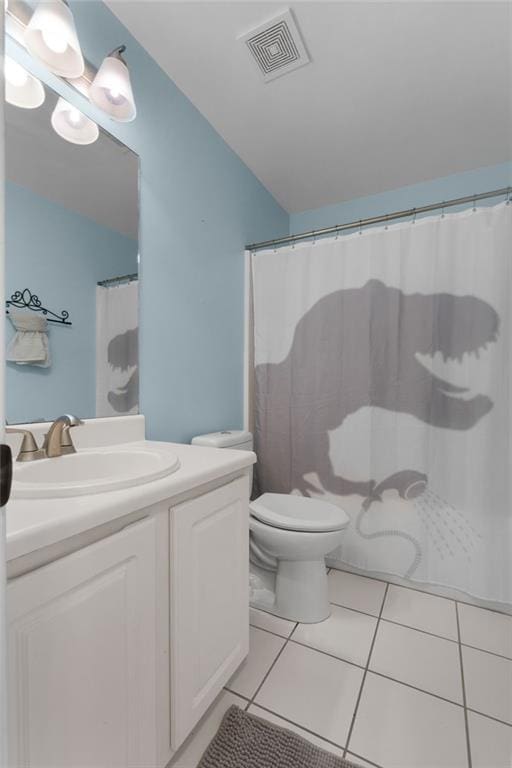 bathroom featuring toilet, vanity, tile patterned flooring, and a shower with curtain