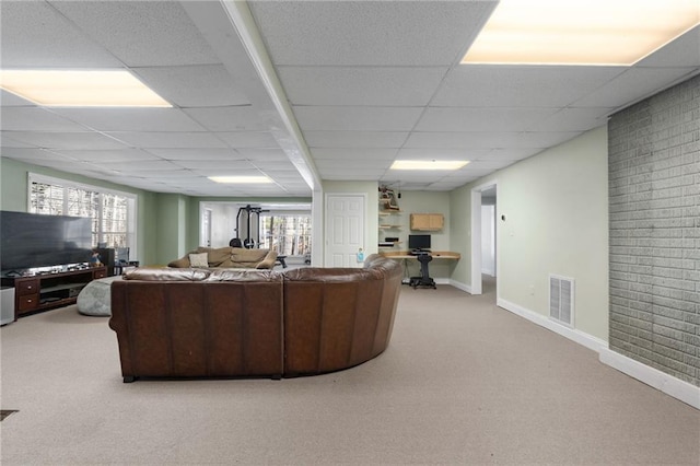 carpeted living room featuring a paneled ceiling