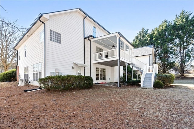 back of house with ceiling fan