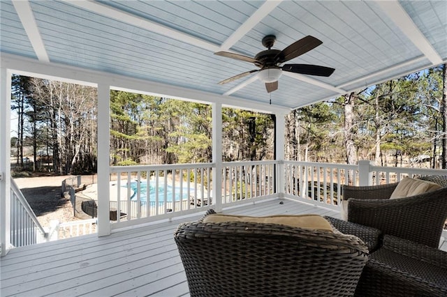 sunroom featuring ceiling fan