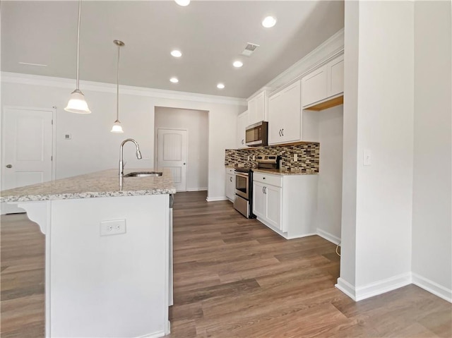 36 Crescent, Dallas, GA 30157 - kitchen with stainless steel appliances, ornamental molding, white cabinetry, backsplash, and a breakfast bar area