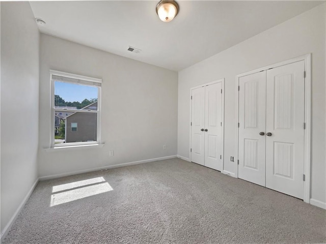 36 Crescent, Dallas, GA 30157 - unfurnished bedroom featuring two closets and carpet