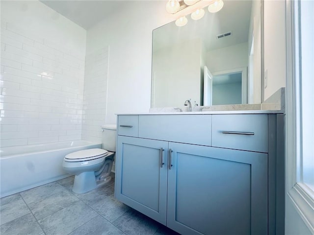 full bathroom featuring vanity, tiled shower / bath, and toilet