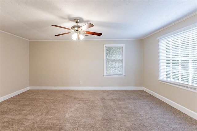 spare room featuring ceiling fan, light colored carpet, and ornamental molding