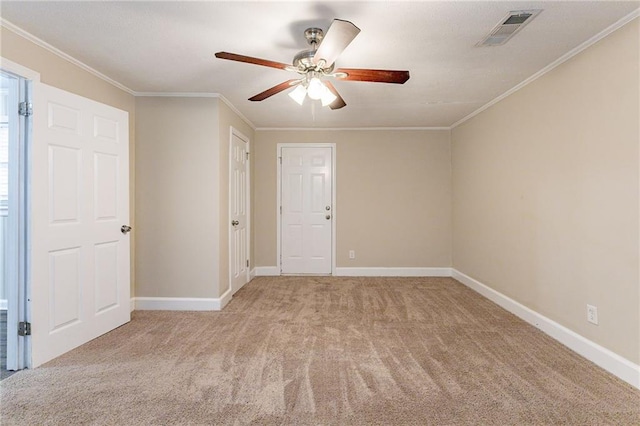 carpeted spare room with ornamental molding and ceiling fan