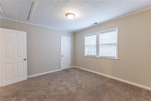 carpeted empty room featuring a textured ceiling and crown molding