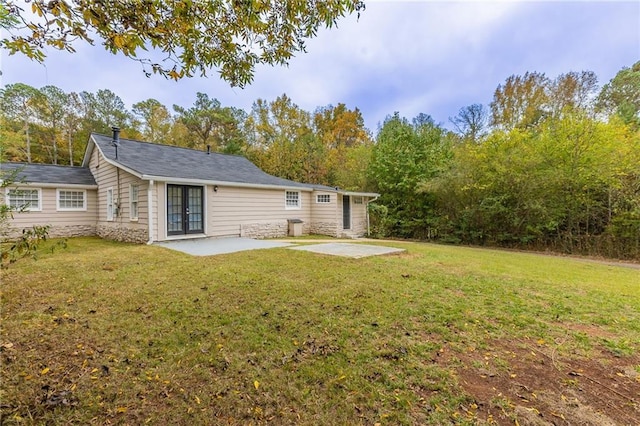 back of house with french doors, a yard, and a patio area