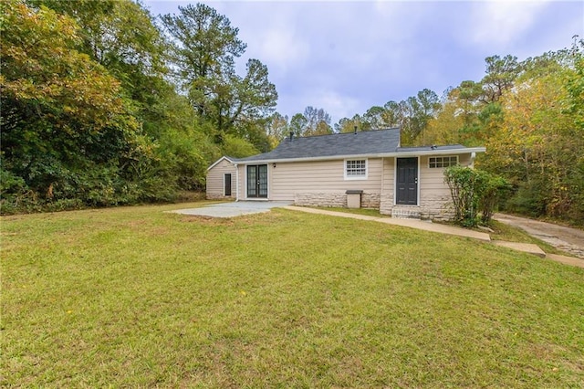 back of property with a patio and a yard