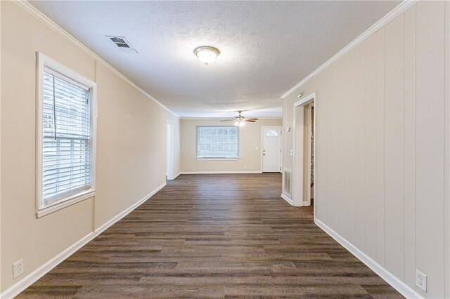 corridor featuring ornamental molding, a textured ceiling, and dark hardwood / wood-style floors