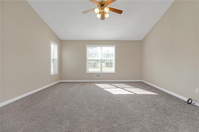 empty room featuring ceiling fan, carpet, and vaulted ceiling