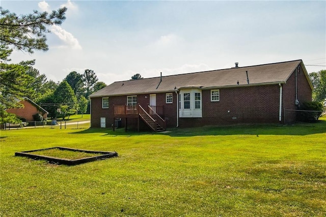 back of house with a lawn