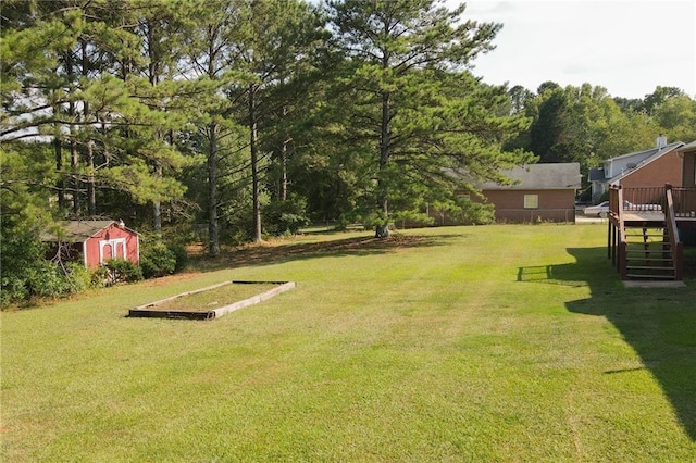 view of yard with a storage unit and a wooden deck