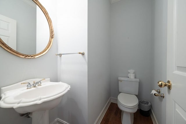 bathroom featuring toilet, hardwood / wood-style flooring, and sink