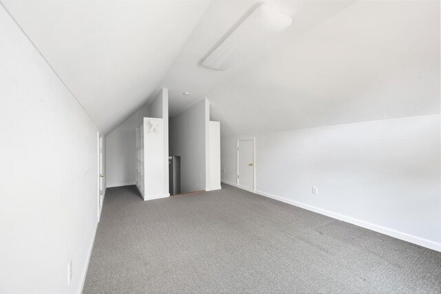 bonus room with carpet and vaulted ceiling