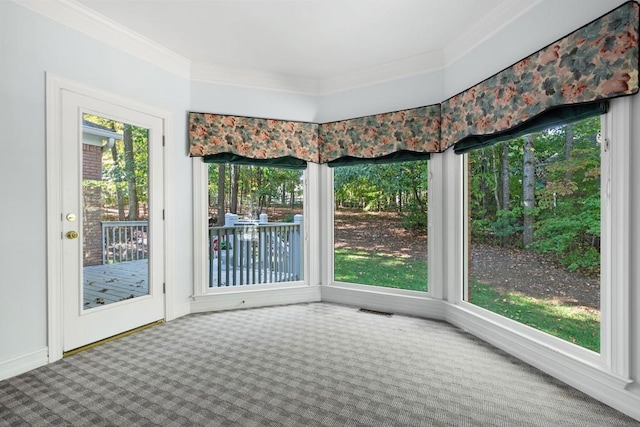 interior space with ornamental molding and carpet