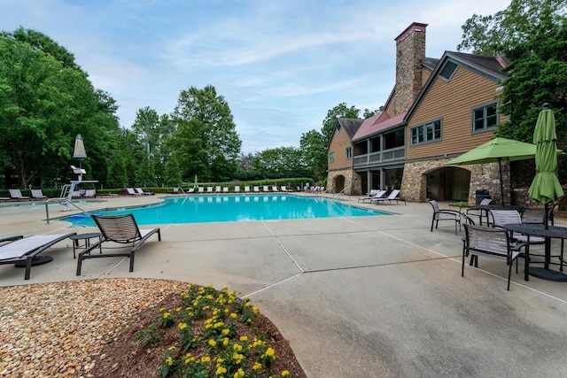 view of swimming pool with a patio