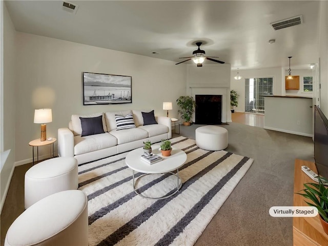 living room featuring ceiling fan and carpet floors