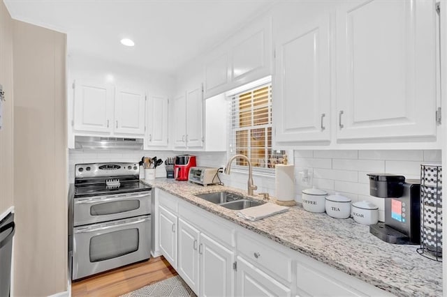 10 Shadow Ln, Cartersville, GA 30120 - kitchen with double oven range, a sink, white cabinetry, under cabinet range hood, and decorative backsplash