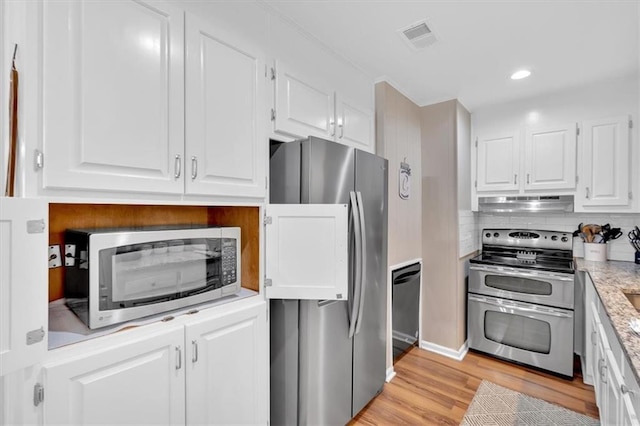 10 Shadow Ln, Cartersville, GA 30120 - kitchen featuring stainless steel appliances, white cabinets, under cabinet range hood, light countertops, and light wood finished floors