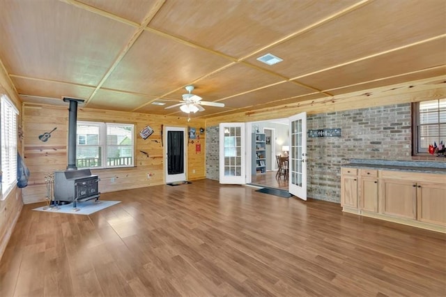 10 Shadow Ln, Cartersville, GA 30120 - unfurnished living room featuring a wood stove, wooden ceiling, wood finished floors, french doors, and a ceiling fan