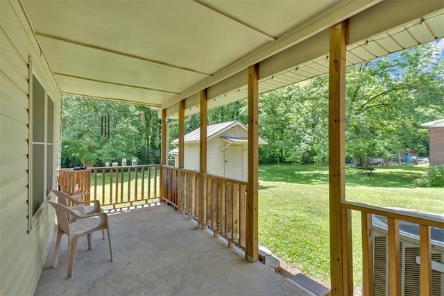 10 Shadow Ln, Cartersville, GA 30120 - covered porch featuring a yard, an outdoor structure, and view of wooded area