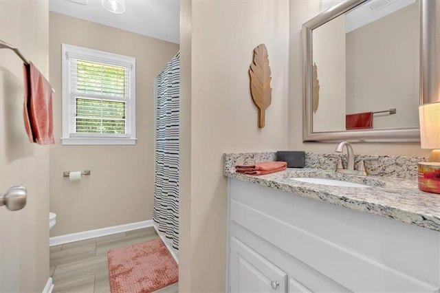10 Shadow Ln, Cartersville, GA 30120 - bathroom featuring toilet, vanity, baseboards, and curtained shower