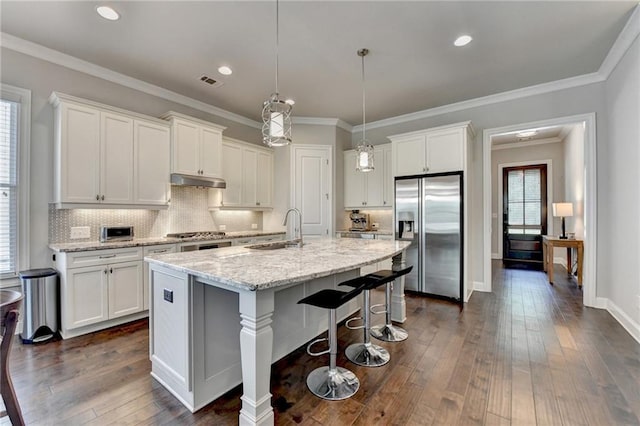 kitchen with visible vents, stainless steel refrigerator with ice dispenser, white cabinets, a sink, and dark wood finished floors