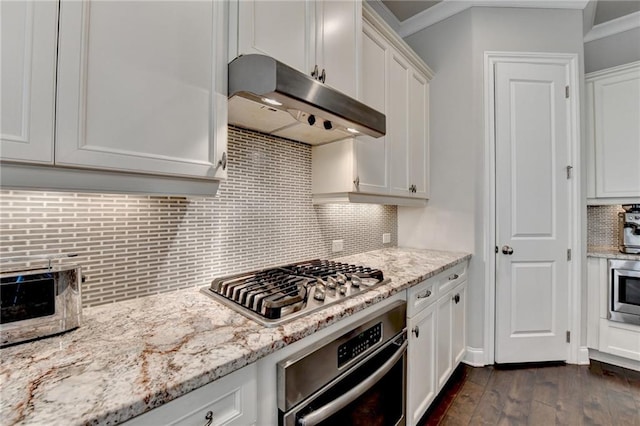 kitchen featuring under cabinet range hood, white cabinets, appliances with stainless steel finishes, and dark wood-type flooring