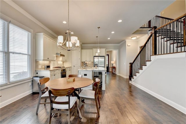dining space featuring stairs, an inviting chandelier, ornamental molding, and a healthy amount of sunlight