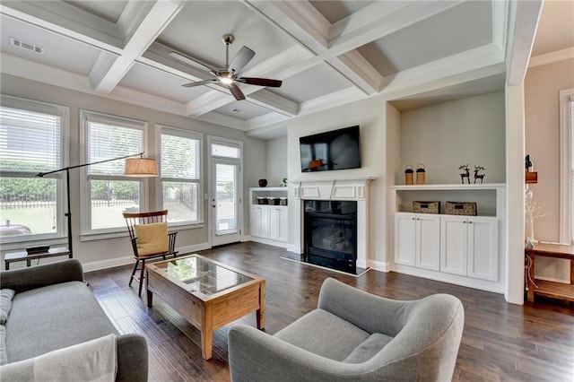 living room with ceiling fan, visible vents, a high end fireplace, beam ceiling, and coffered ceiling