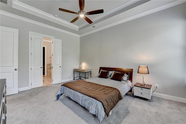 carpeted bedroom featuring baseboards, a tray ceiling, and visible vents