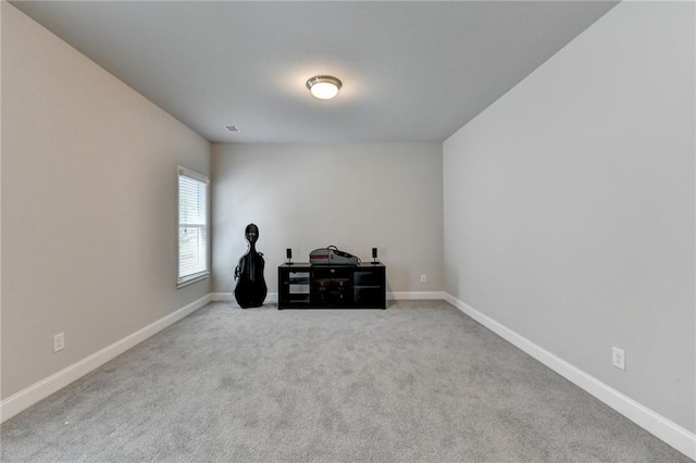 carpeted empty room with baseboards and visible vents