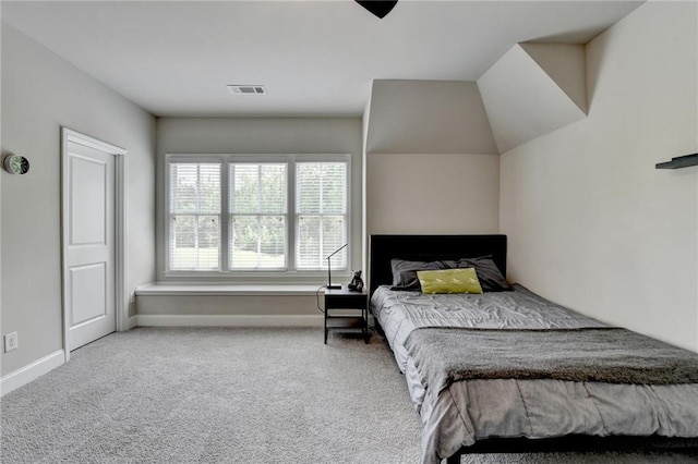 carpeted bedroom featuring baseboards and visible vents