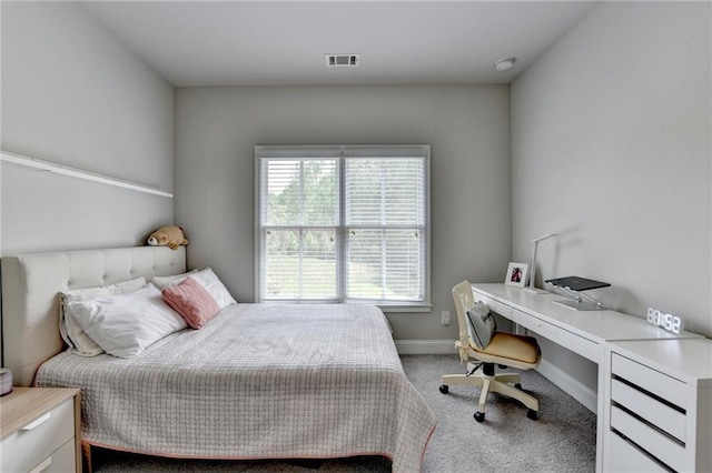 carpeted bedroom featuring baseboards and visible vents