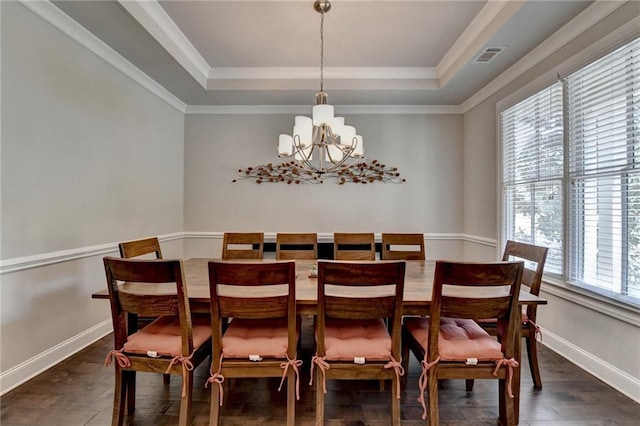 dining space with a tray ceiling, an inviting chandelier, baseboards, and dark wood-type flooring