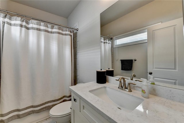 bathroom featuring vanity, a shower with shower curtain, and toilet